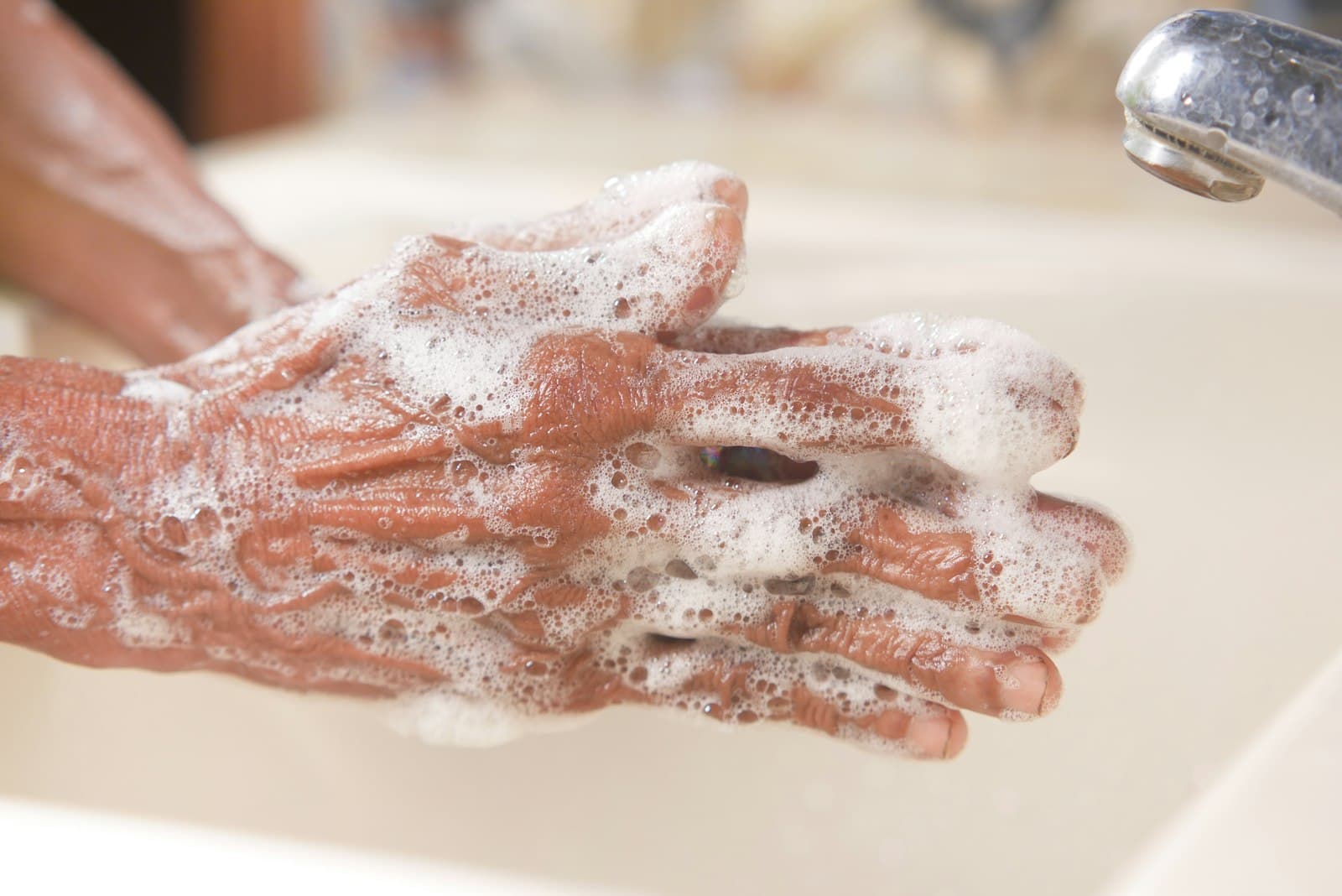 Washing hands thoroughly with soap and water